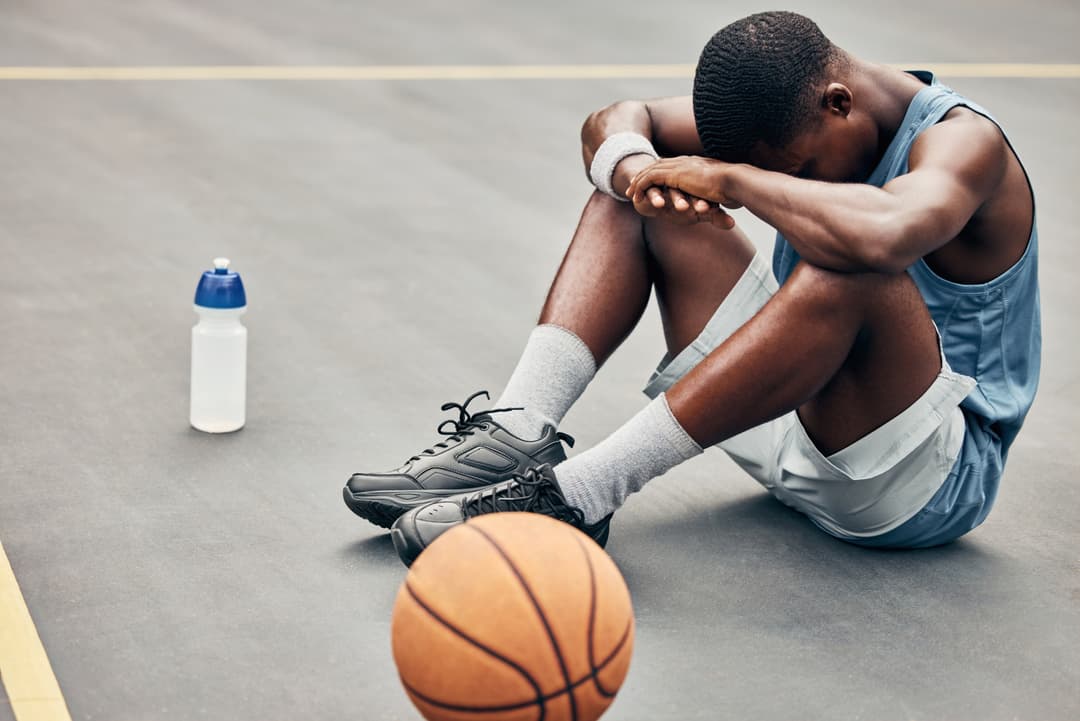 teen basketball player suffering from performance anxiety