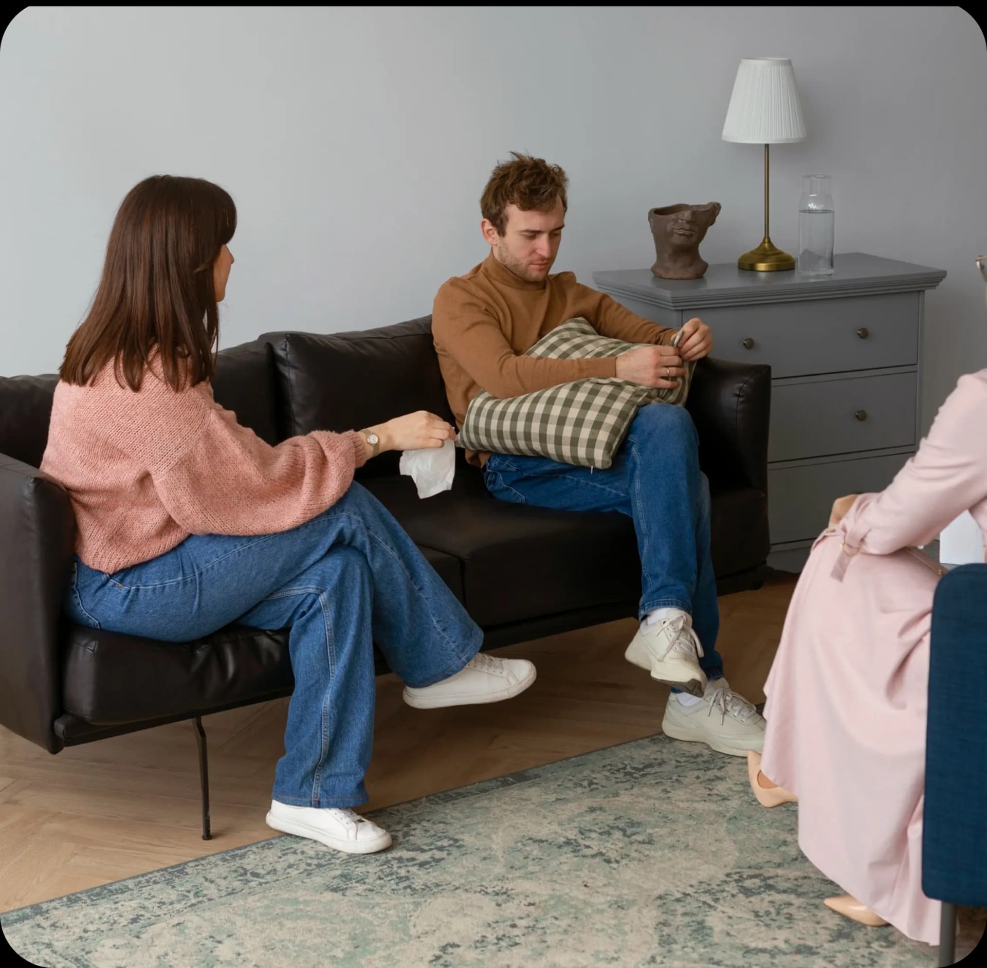 Couples therapy session showing therapist and couple in a comfortable, professional setting
