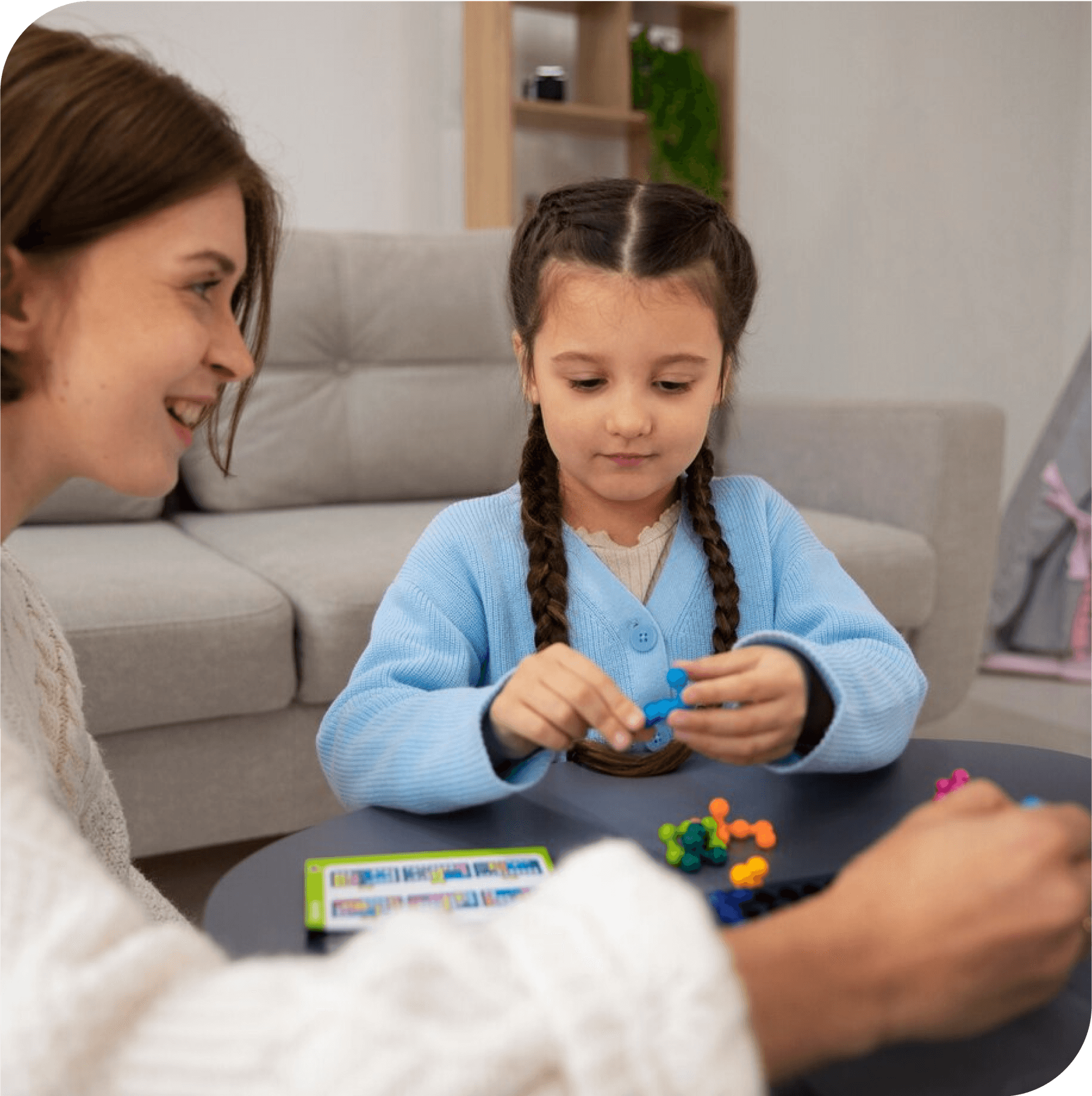 Mother and child in play therapy, strengthening their bond. Family play therapy in Thornhill, Vaughan, at Young Sprouts Therapy.