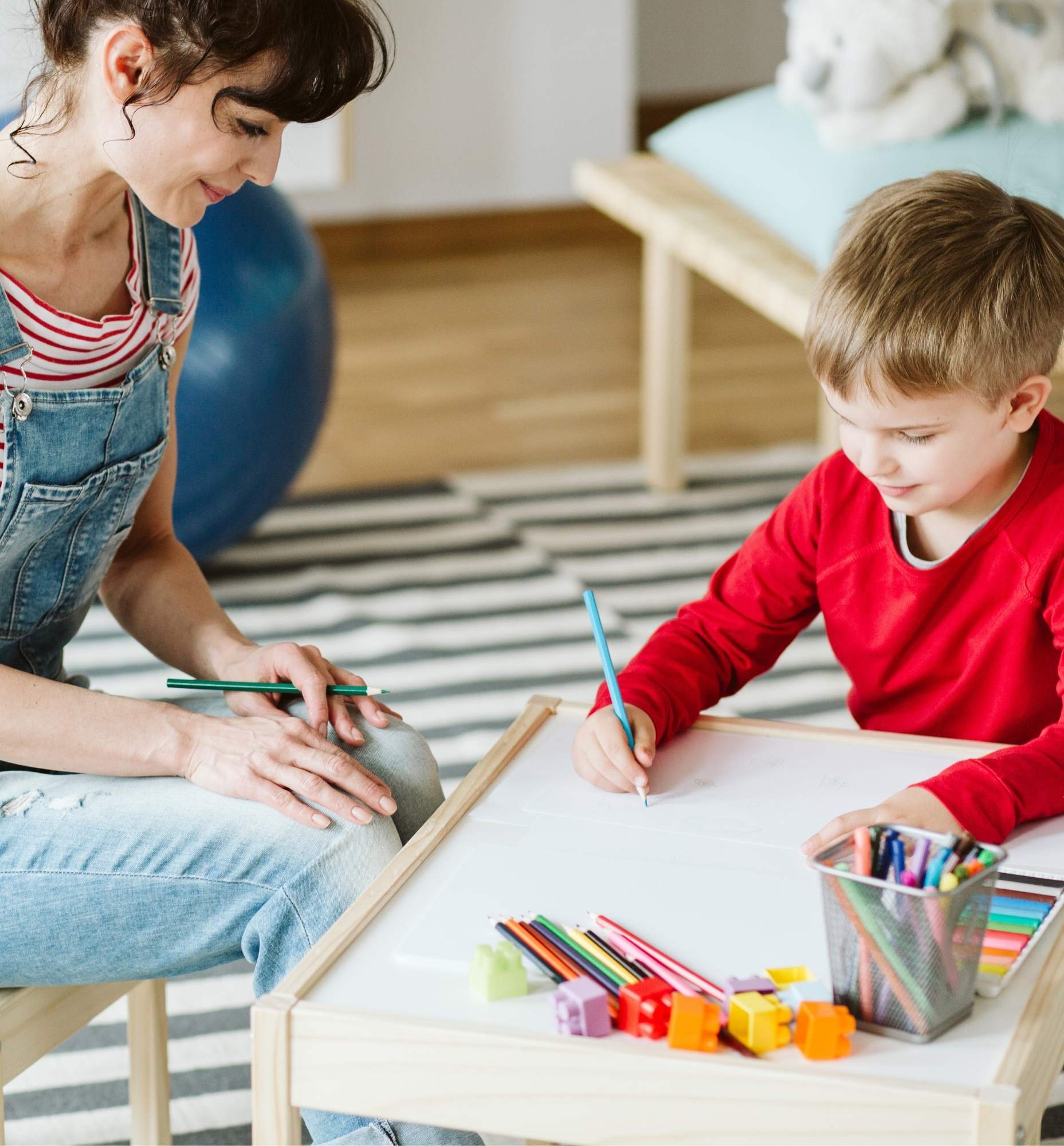 Occupational therapist helping a child with handwriting.