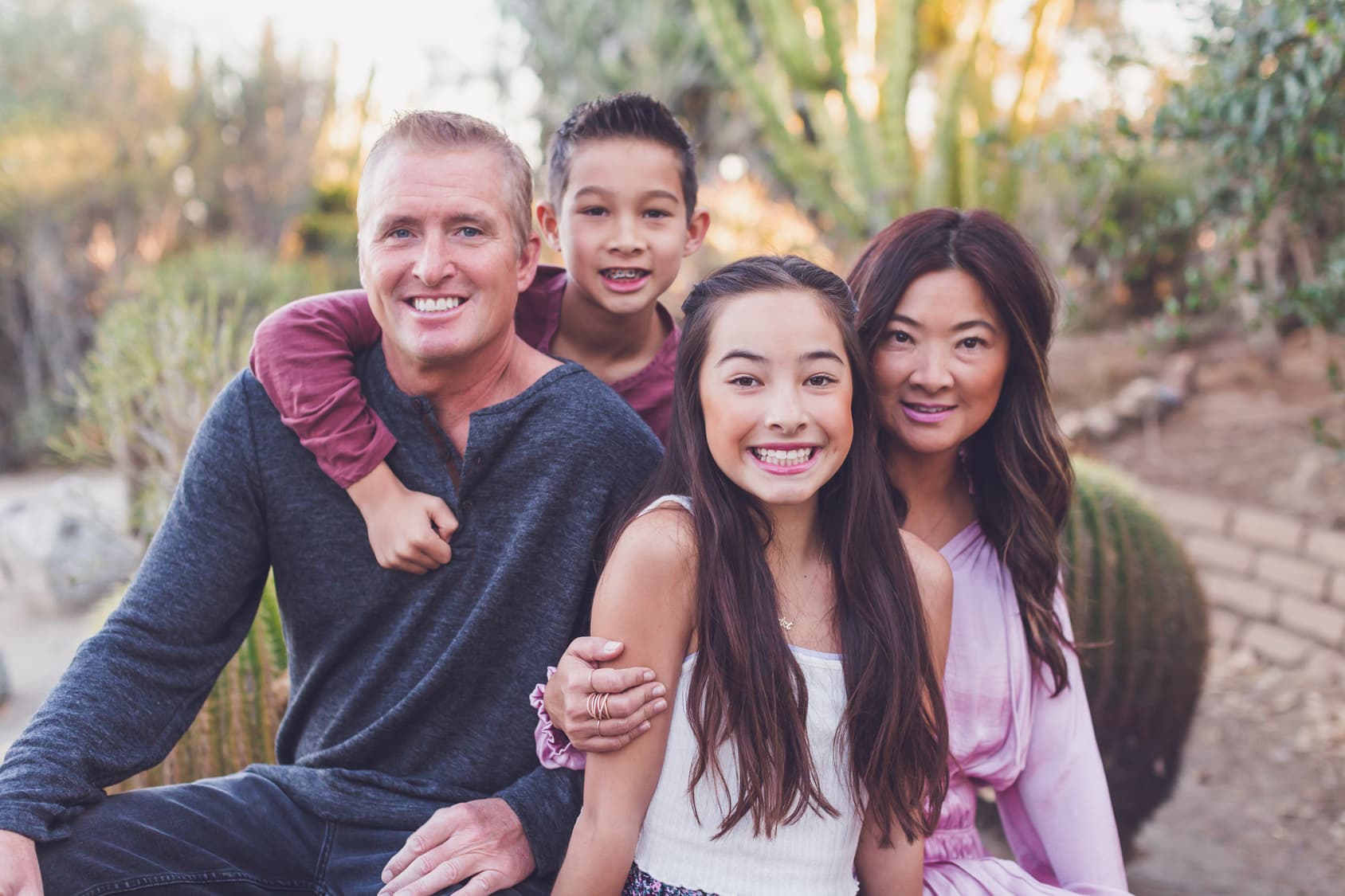 A smiling teen girl with her family