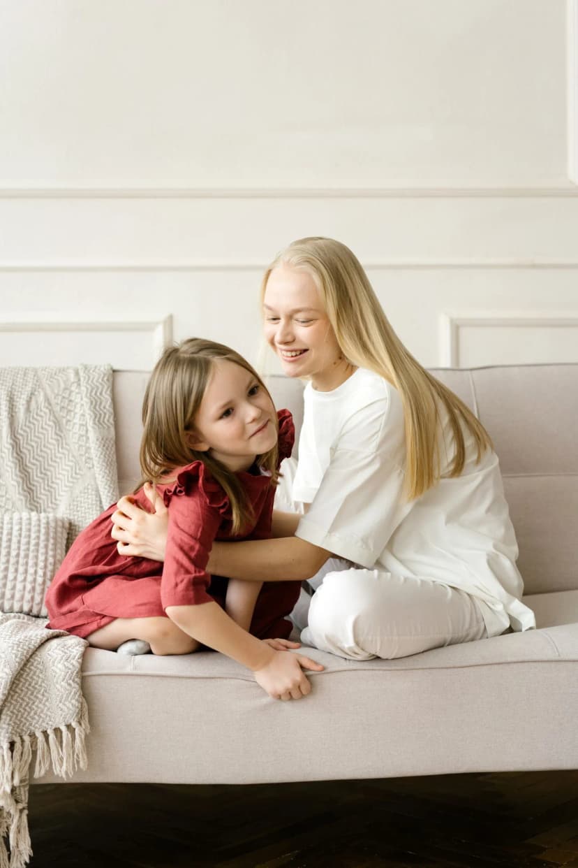 Parent comforting a grieving child on the couch at home in Vaughan Parent comforting a grieving child on the couch at home in Vaughan