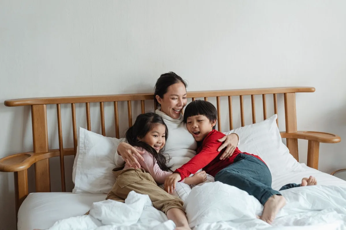 Parent hugging children at home, a safe space for self-regulation after school