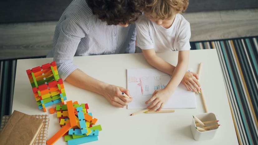 A child therapist and young boy drawing together at a table with building blocks nearby — supportive, child-centred care for childhood OCD and anxiety in Vaughan, Ontario A child therapist and young boy drawing together at a table with building blocks nearby — supportive, child-centred care for childhood OCD and anxiety in Vaughan, Ontario
