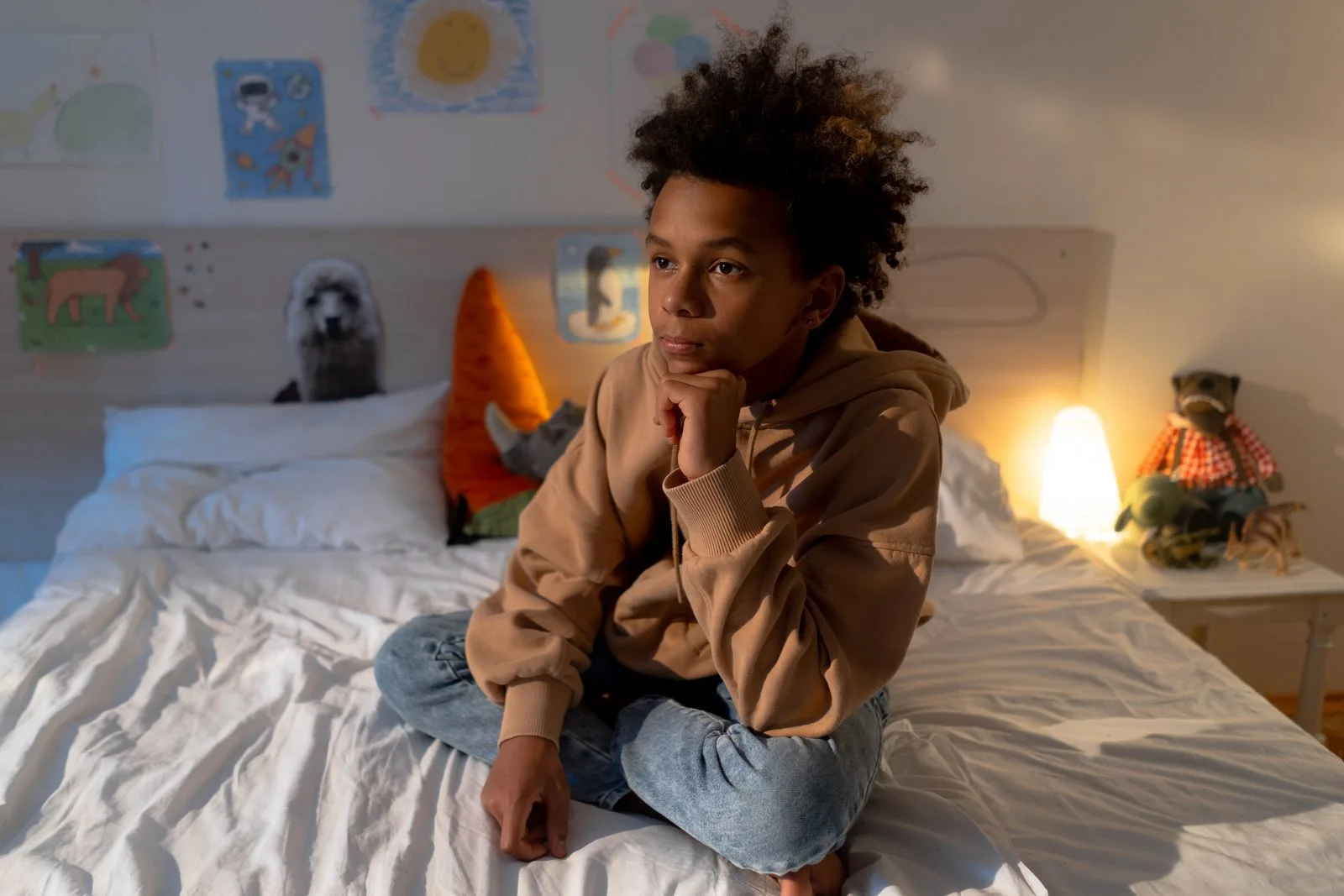 Teen sitting alone on their bed, a common moment when a teen refuses therapy
