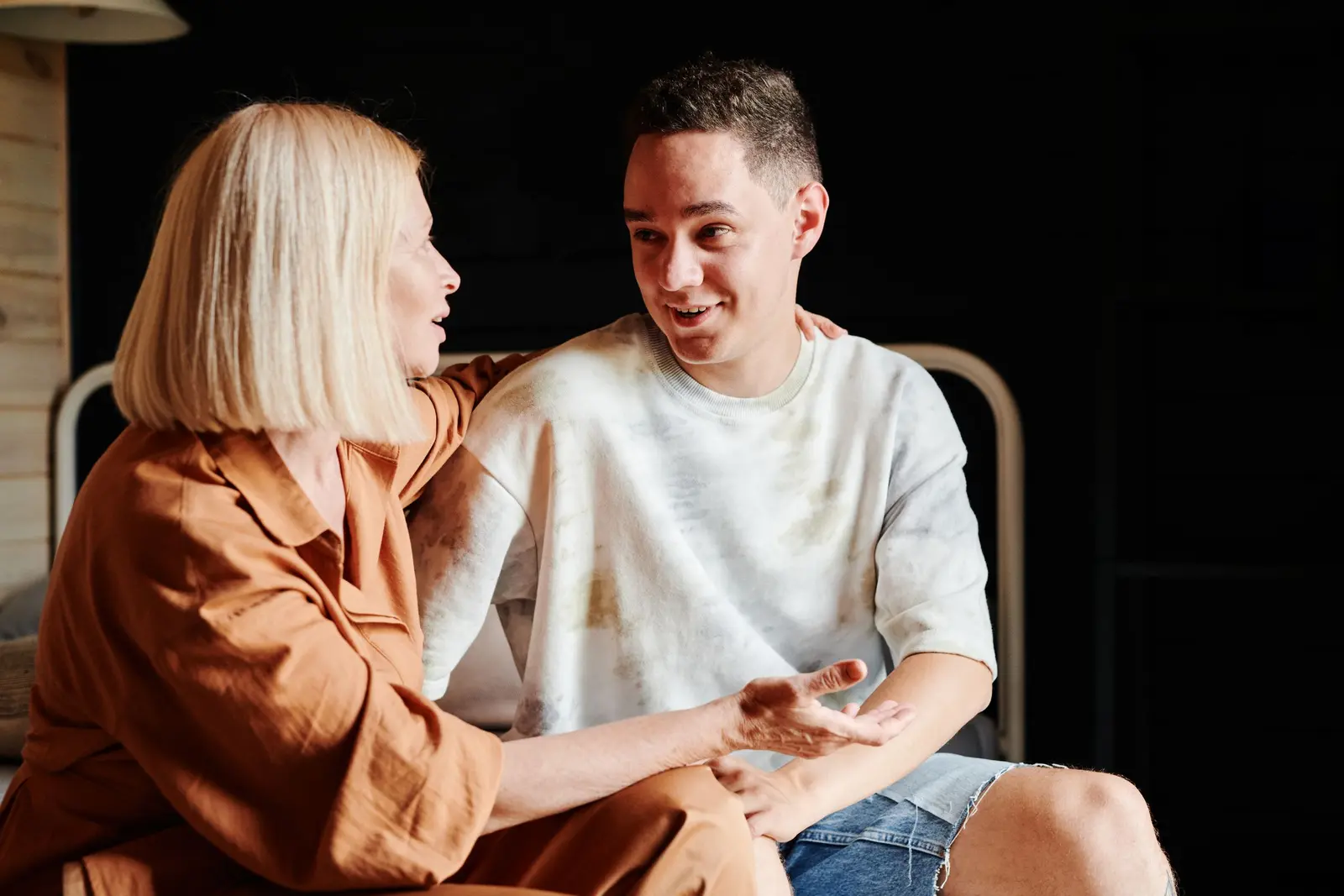 Parent and teenager talking calmly indoors