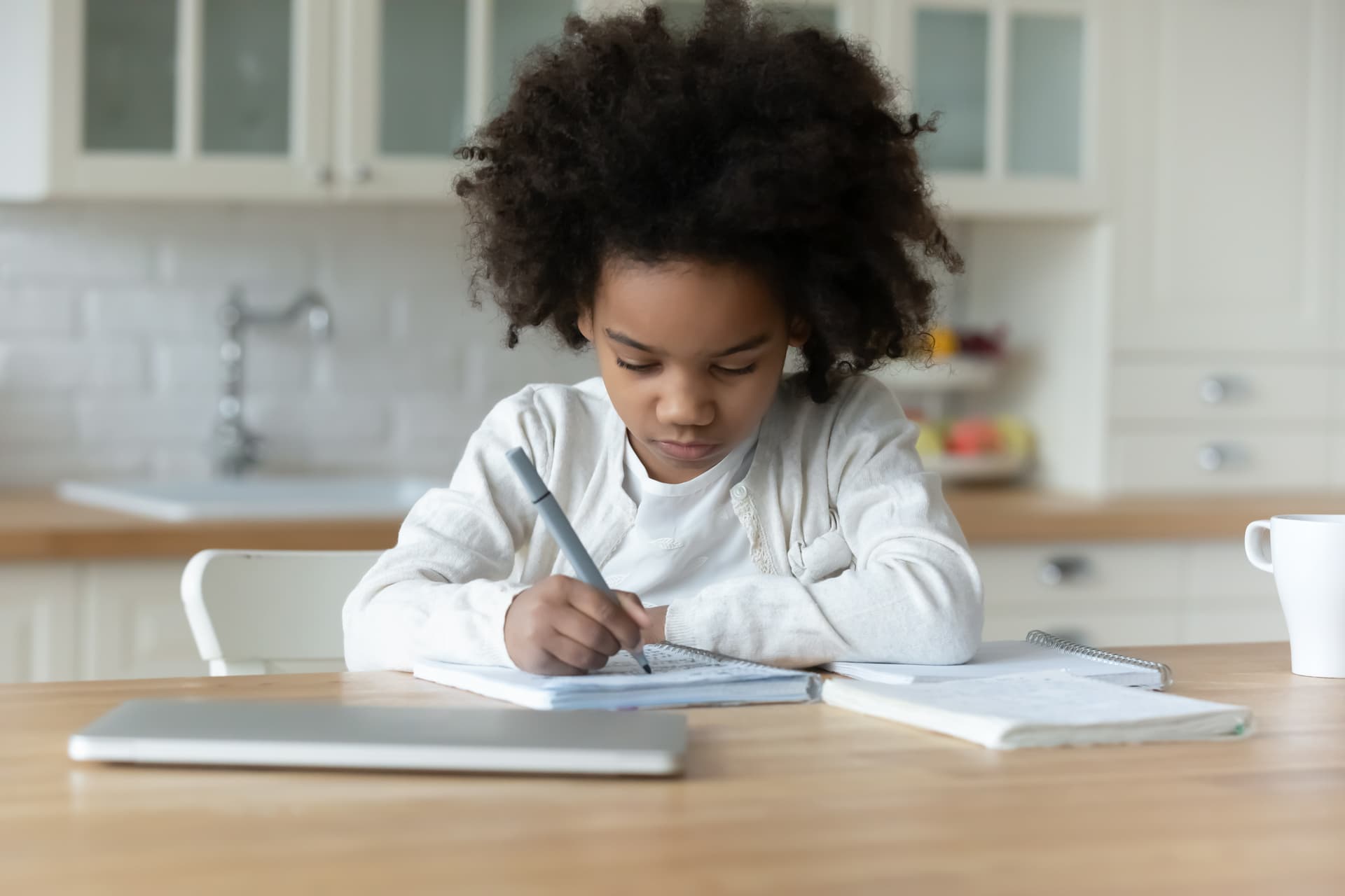 Child developing attention and focus skills through writing activity during occupational therapy in Vaughan