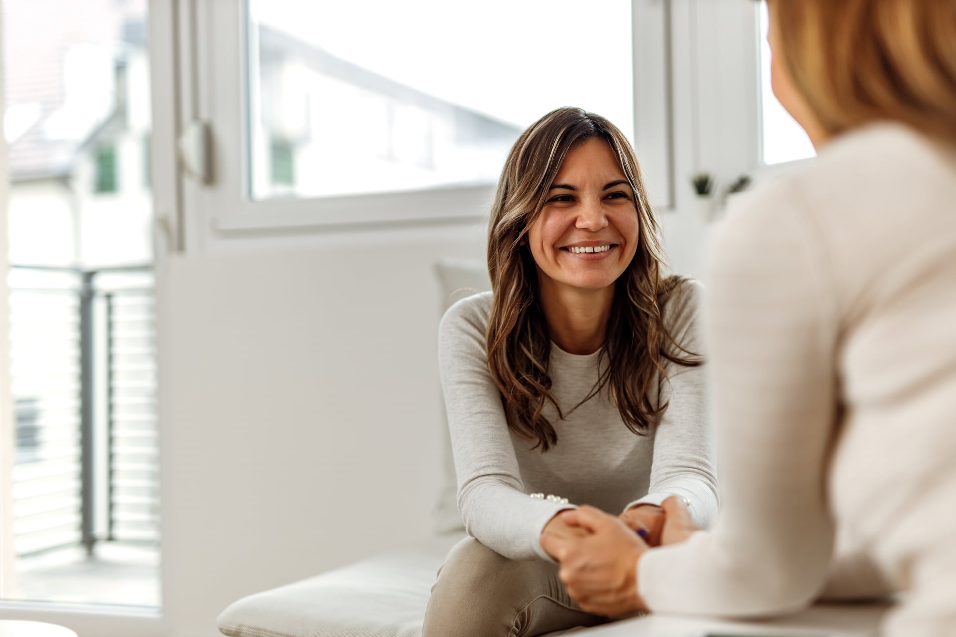 Client talking with a compassionate registered psychotherapist in a warm clinic room