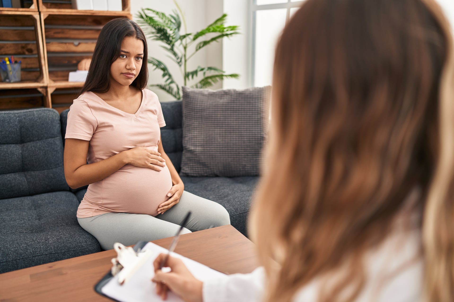 Expecting parent speaking with a therapist about emotions and adjustment in a calm Thornhill counselling office