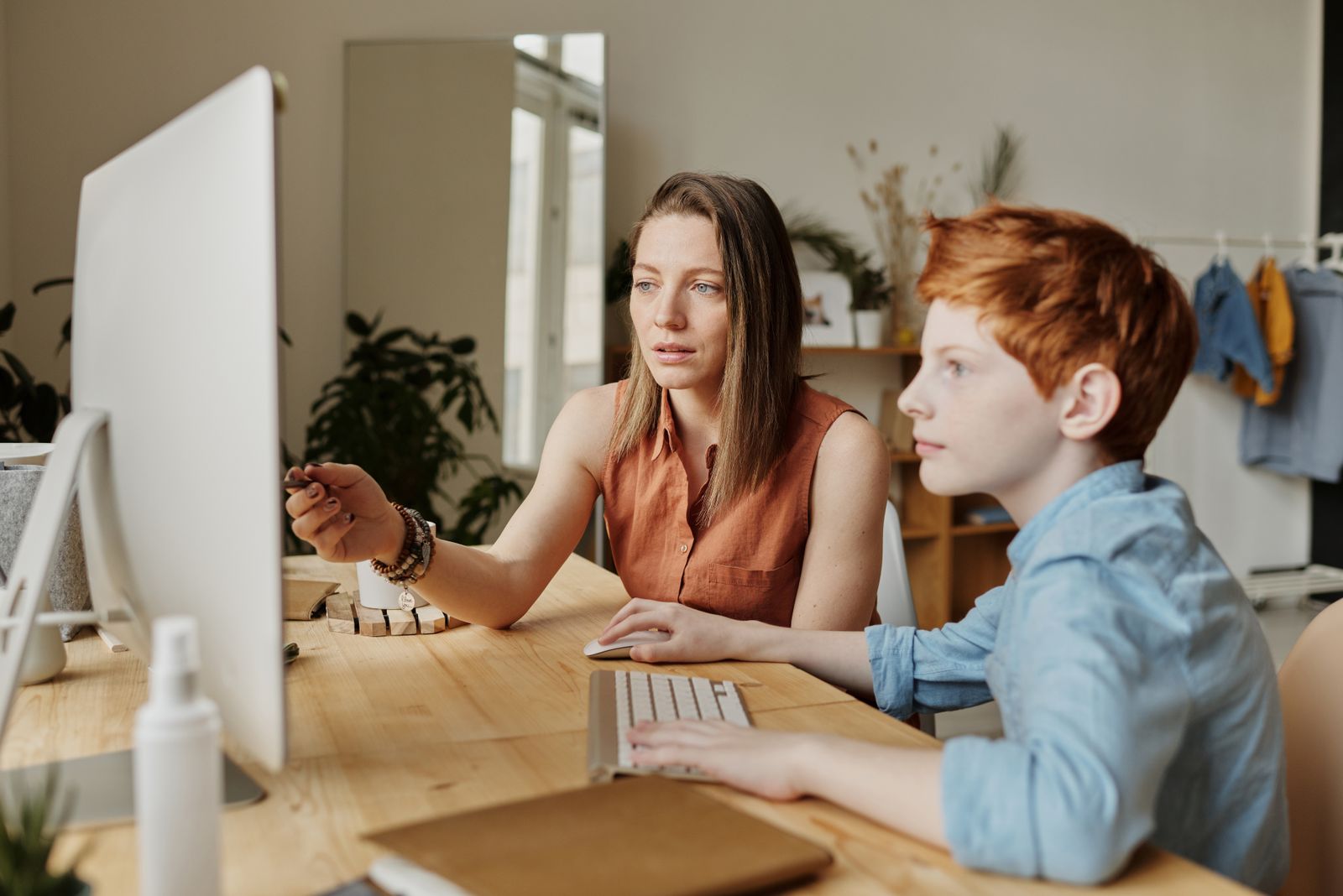 Adult guiding a focused child through a structured learning task that supports attention and organization