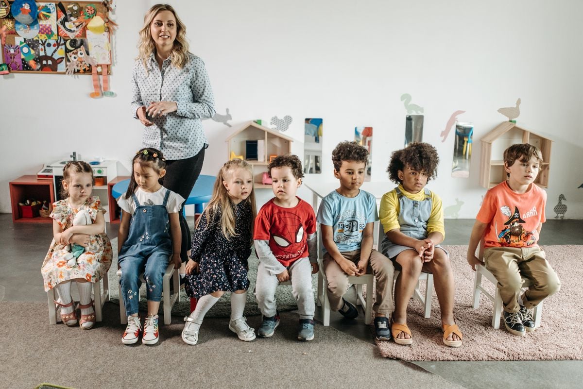 Children practising sitting attention and classroom readiness with a supervising adult