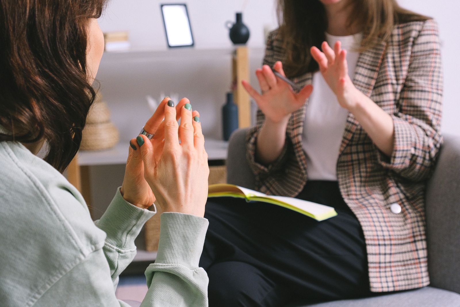 Therapist and parent discussing a child’s occupational therapy goals during a supportive consultation