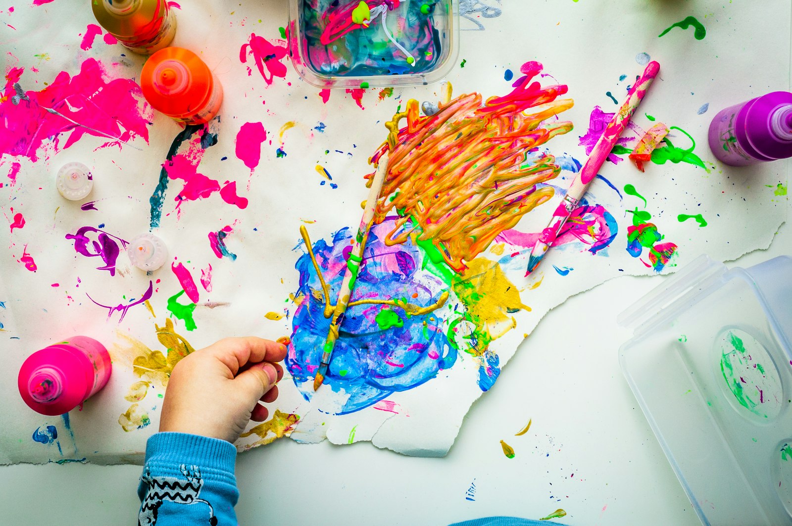 Child exploring messy sensory paint play during pediatric occupational therapy