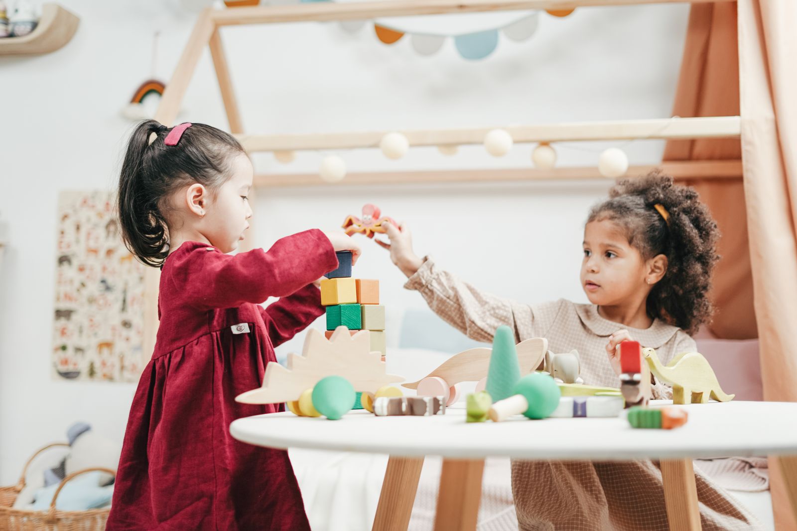 Children stacking colourful wooden blocks to build visual-spatial and visual-motor skills