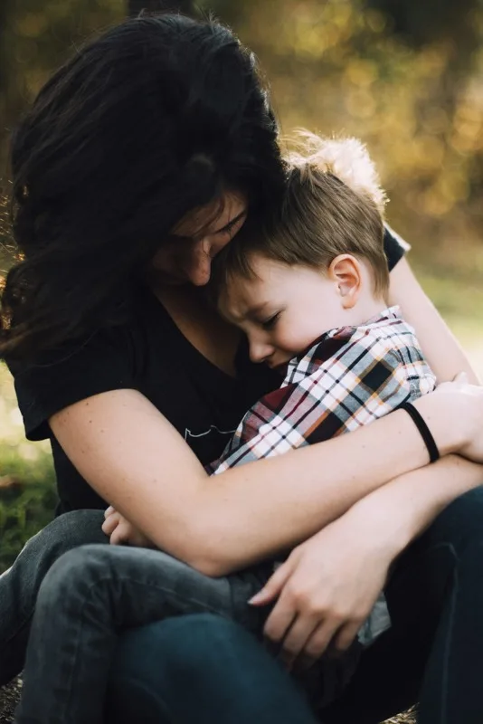 Parent comforting child during an after-school emotional moment