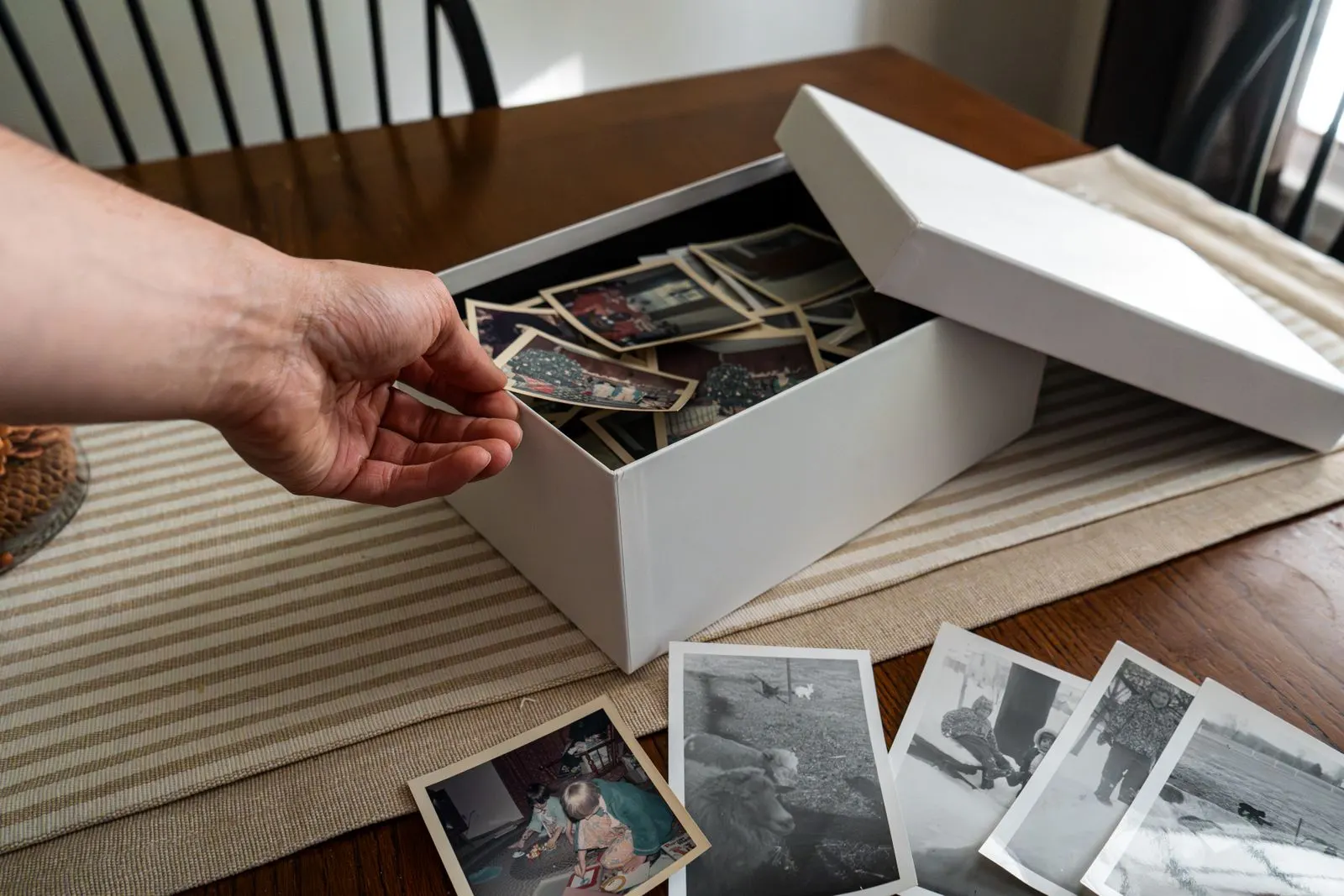 Parent and child making a memory box with photos to remember a loved one who died