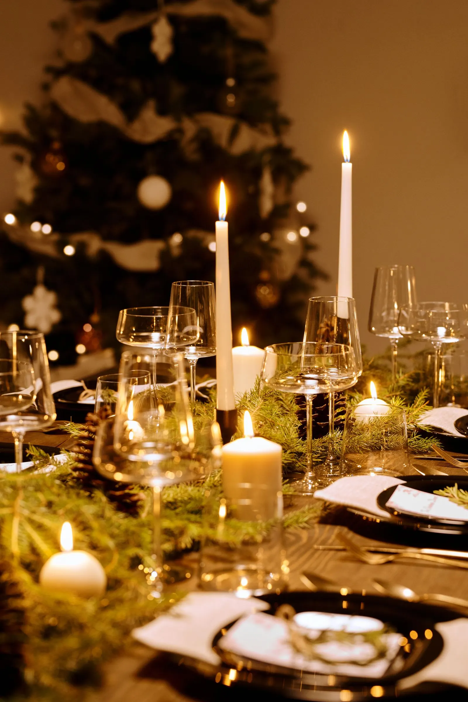Family lighting a candle at a holiday table to remember a loved one