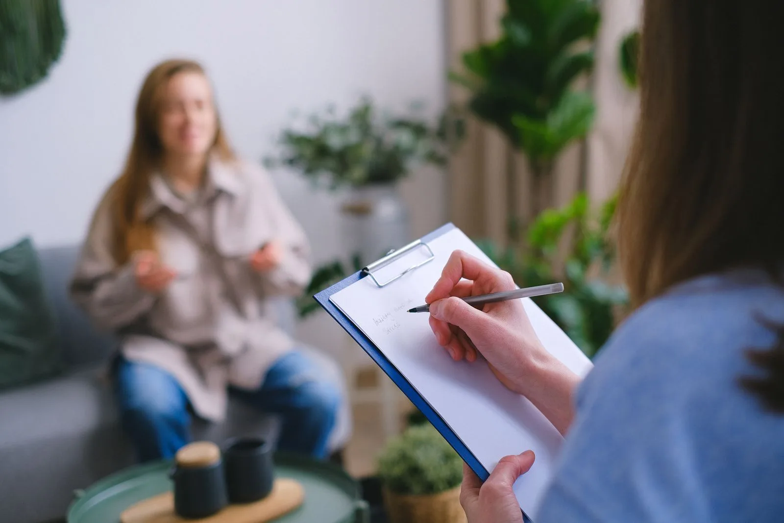 Parent meeting with a therapist for a parent coaching session in a calm office