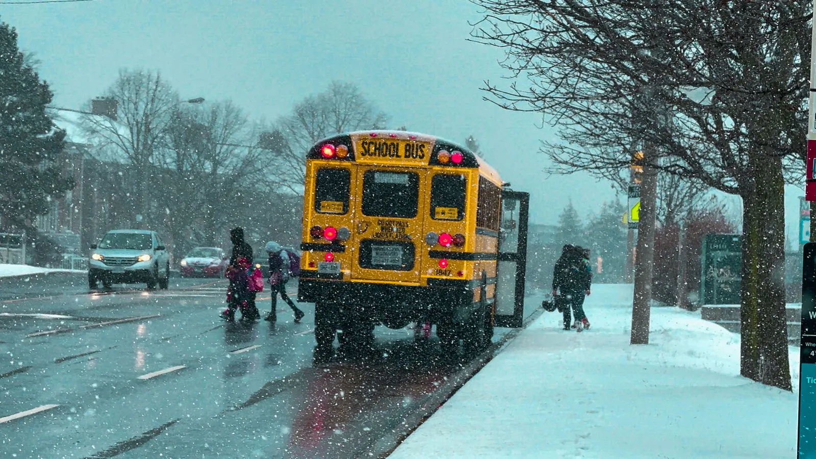 Teen walking to school in the dark on a winter morning, showing how little daylight Ontario teens get