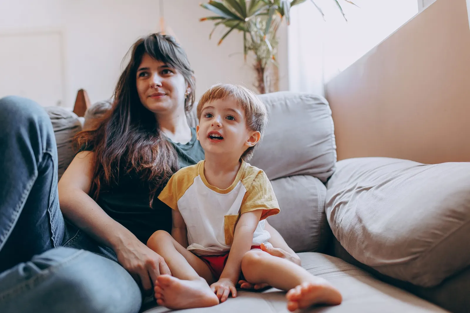 Parent and young child sitting together on a sofa